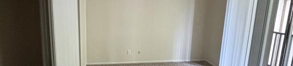 A room with a skylight and a grey wall.